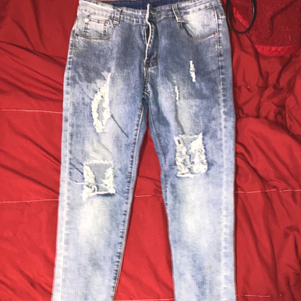 Blue cut jeans with zippers on ankles.